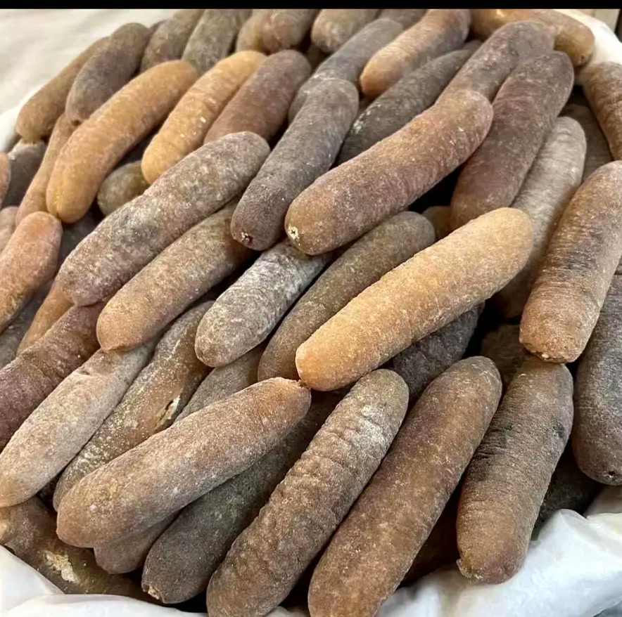 Batch of brown-toned dried sea cucumbers in a lined basin